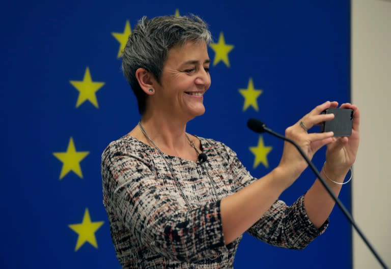 European Commissioner for Competition Margrethe Vestager takes pictures of journalists using her iPhone at the EU Delegation in Washington