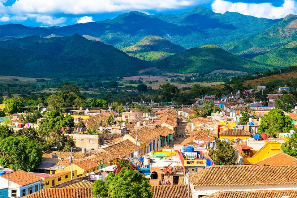 <p>Colorful houses stand in a valley below the Escambray mountains of Trinidad, Cuba // Date unknown</p>