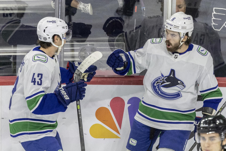 Vancouver Canucks right wing Conor Garland, right, celebrates his goal with Quinn Hughes (43) during the first period of an NHL hockey game against the Philadelphia Flyers, Saturday, Oct. 15, 2022, in Philadelphia. (AP Photo/Laurence Kesterson)