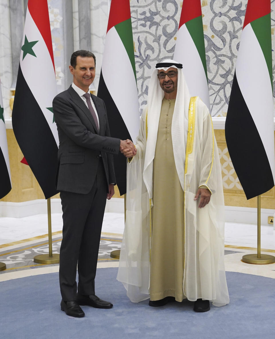 In this photo released by the Syrian Presidency, Syrian President Bashar Assad, left, shakes hands with UAE President Sheikh Mohammed bin Zayed Al-Nahyan, in Abu Dhabi, United Arab Emirates, Sunday, March 19, 2023. Assad arrived in the United Arab Emirates Sunday, his first visit to the wealthy Guf country since the devastating earthquake that struck Turkey and Syria last month. (Syrian Presidency via AP)