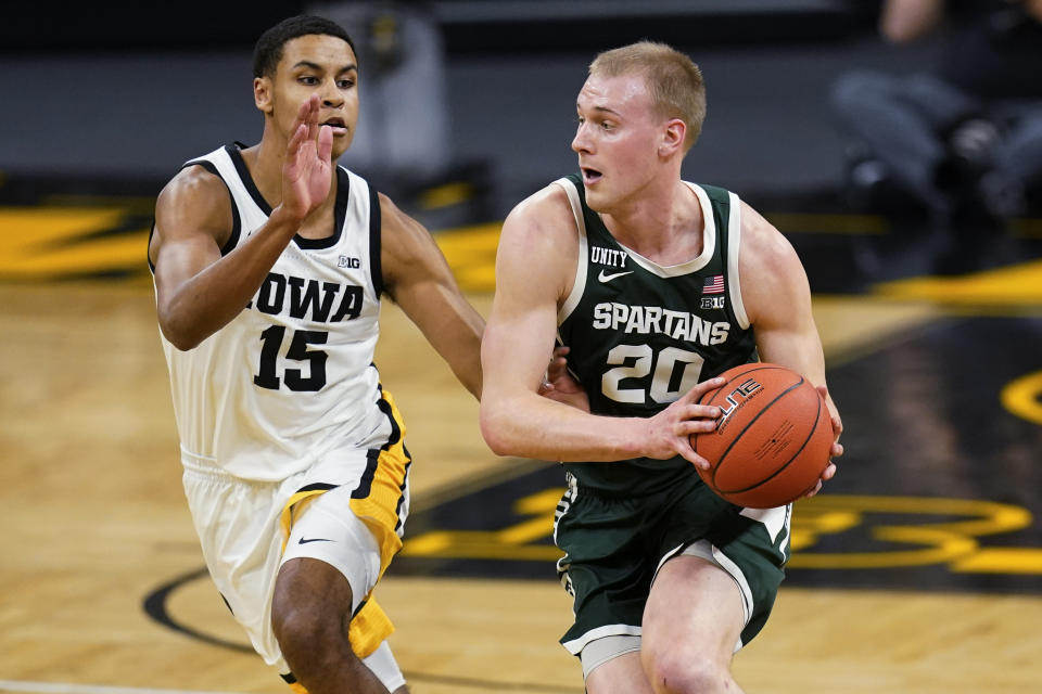 FILE - In this Feb. 2, 2021, file photo, Michigan State forward Joey Hauser (20) drives upcourt ahead of Iowa forward Keegan Murray (15) during the first half of an NCAA college basketball game in Iowa City, Iowa. The Spartans will lean on Hauser to be a consistent leader after an up-and-down season left him with a 9.7 scoring average last year. (AP Photo/Charlie Neibergall, File)
