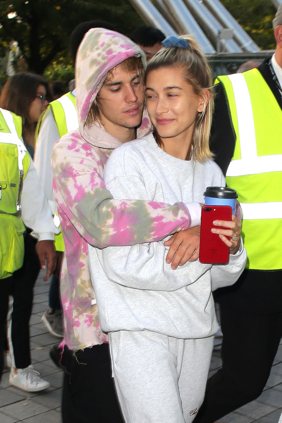 Justin with his arms around Hailey. They're both dressed casually in sweats