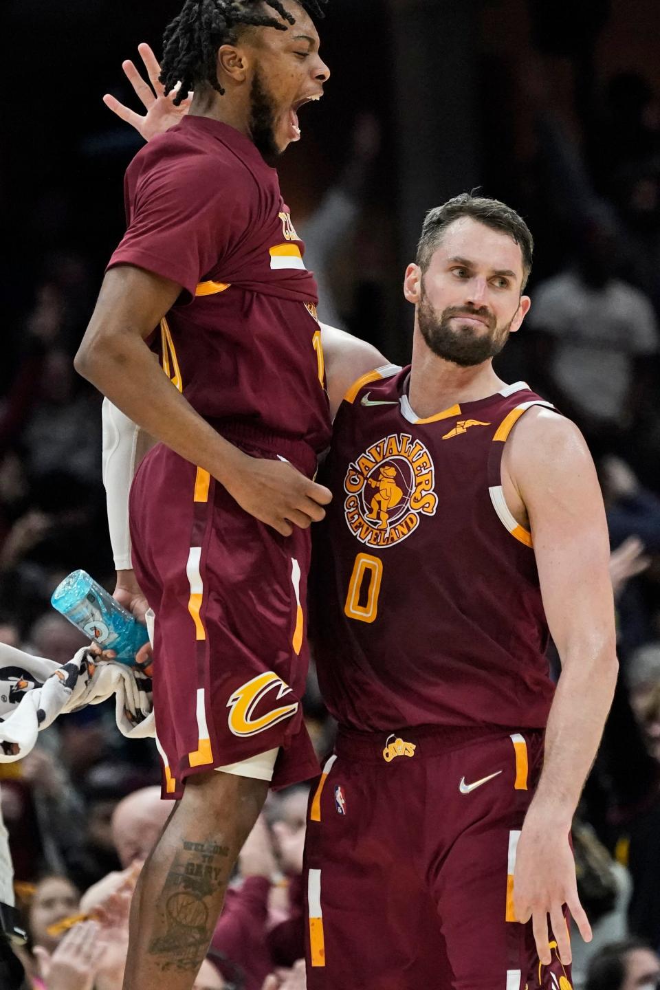 Cavaliers guard Darius Garland, left, congratulates Kevin Love after Love made a 3-pointer during a game earlier this season. Garland has emerged as a leader of the surprising young Cavs and stars around the league are taking notice. [Tony Dejak/Associated Press]