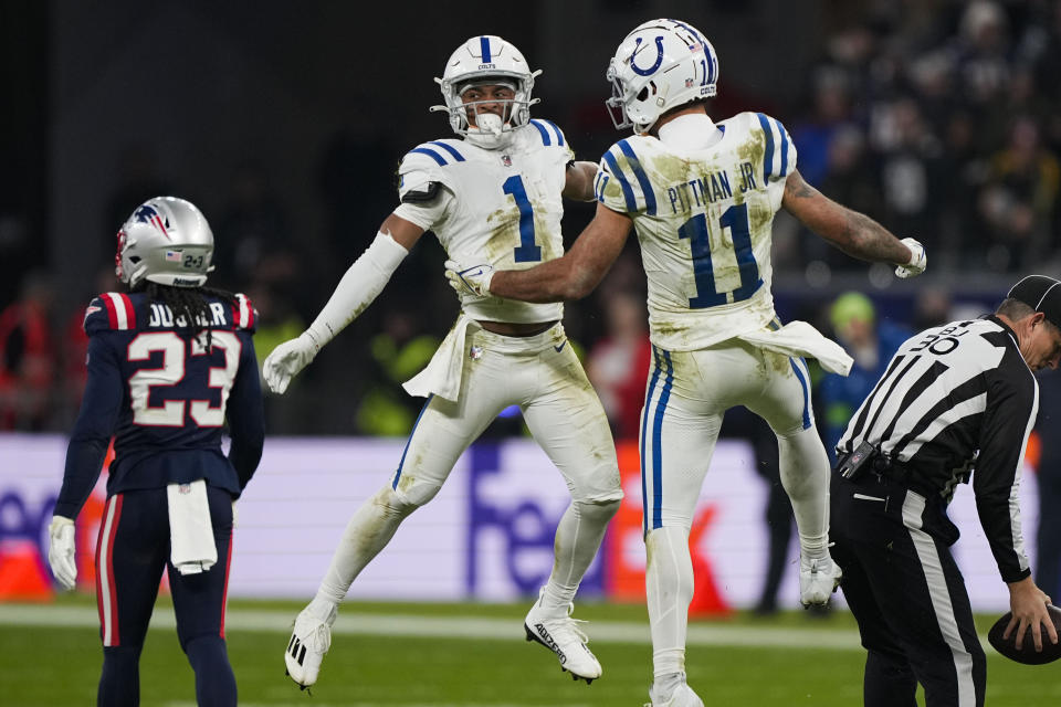 Indianapolis Colts wide receiver Josh Downs (1) celebrates his long pass reception with wide receiver Michael Pittman Jr. (11) in the second half of an NFL football game against the New England Patriots in Frankfurt, Germany Sunday, Nov. 12, 2023. (AP Photo/Martin Meissner)