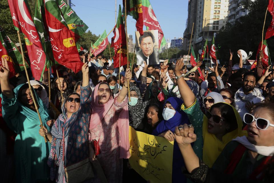 Supporters of former Pakistani Prime Minister Imran Khan's party, 'Pakistan Tehreek-e-Insaf' chant slogans during a protest to condemn a shooting incident on their leader's convoy, in Karachi, Pakistan, Friday, Nov. 4, 2022. Khan who narrowly escaped an assassination attempt on his life the previous day when a gunman fired multiple shots and wounded him in the leg during a protest rally is listed in stable condition after undergoing surgery at a hospital, a senior leader from his party said Friday. (AP Photo/Fareed Khan)