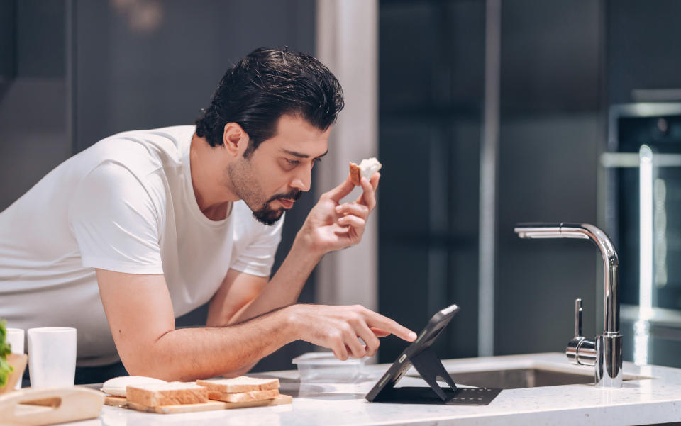 stressed person eating a sandwich