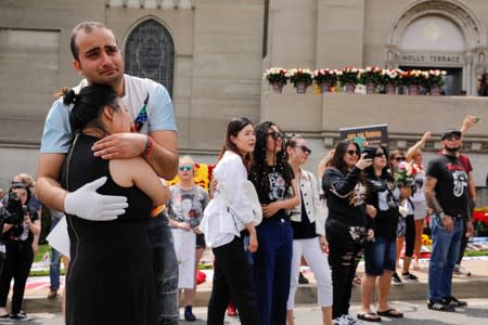 Argon Torosian hugs Wang You Xi of China after a moment of silence at Forest Lawn Cemetery ten years after the death of child star turned King of Pop, Michael Jackson, in Glendale, California