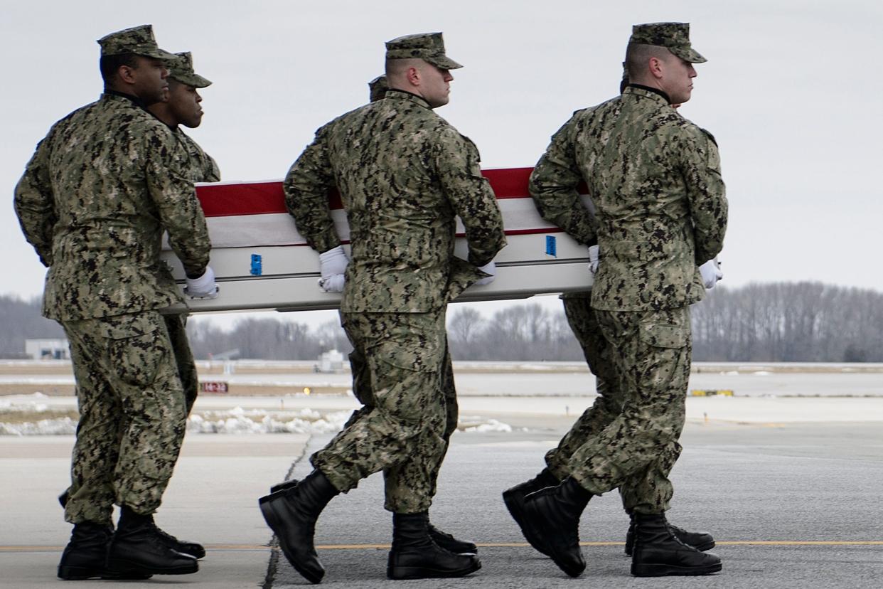 US President Donald Trump salutes as the remains of Scott A. Wirtz, a Defense Intelligence Agency civilian and former Navy Seal, are carried by during a dignified transfer for US personal killed in a suicide bombing in Syria, at Dover Air Force Base January 19, 2019 in Dover, Delaware.