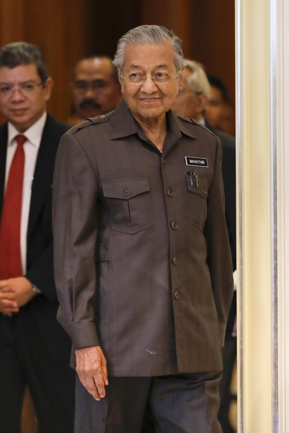 Malaysian Prime Minister Mahathir Mohamad arrives for a press conference in Putrajaya, Malaysia, Monday, April 15, 2019. Malaysia's government decided to resume a China-backed rail link project, after the Chinese contractor agreed to cut the construction cost by one-third. (AP Photo/Vincent Thian)