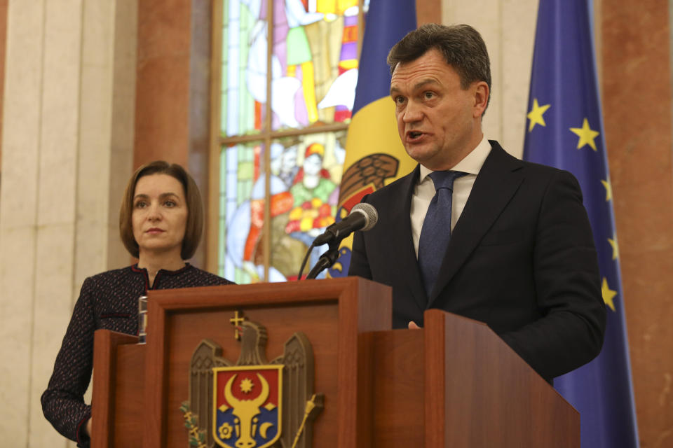 Moldovan Prime Minister designate Dorin Recean speaks after being appointed by President Maia Sandu, left, to form a new government in Chisinau, Moldova, Friday, Feb 10, 2023. Moldova's government collapsed Friday as pro-Western Prime Minister Natalia Gavrilita resigned, adding to a series of crises that have gripped the small nation since Russia invaded its neighbor, Ukraine.(AP Photo/Aurel Obreja)