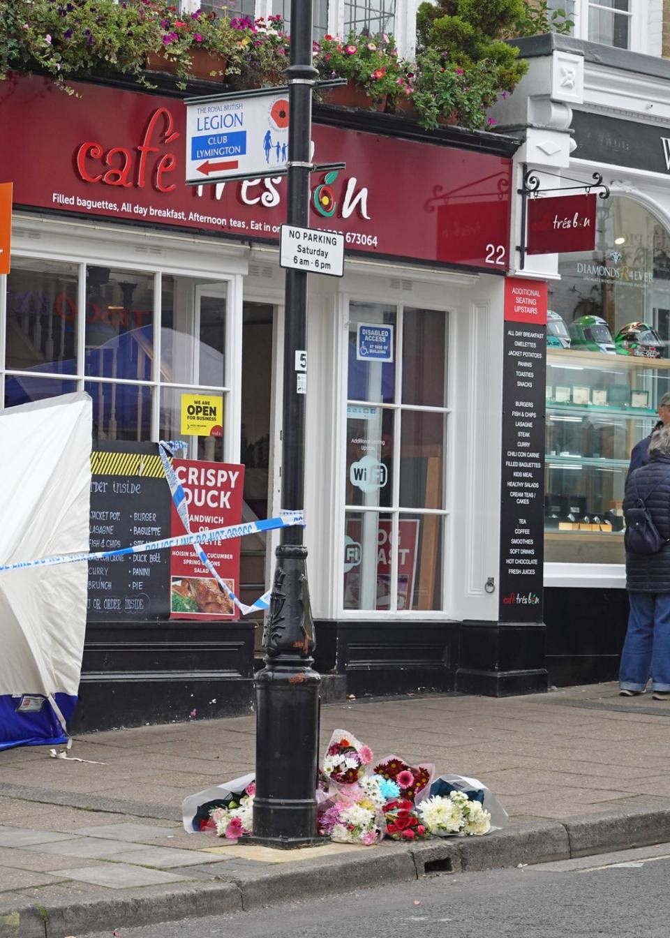 Flowers at the scene outside the Royal British Legion on High Street in Lymington, Hampshire, where two men and a woman were found with stab wounds on Friday (Brian Farmer/PA) (PA Wire)