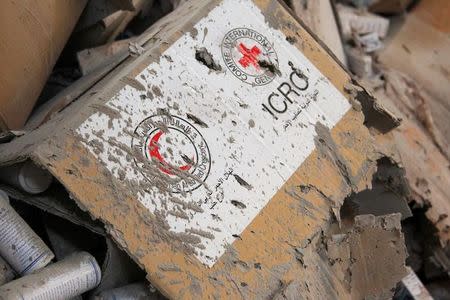 Damaged Red Cross and Red Crescent medical supplies lie inside a warehouse after an airstrike on the rebel held Urm al-Kubra town, western Aleppo city, Syria September 20, 2016. REUTERS/Ammar Abdullah