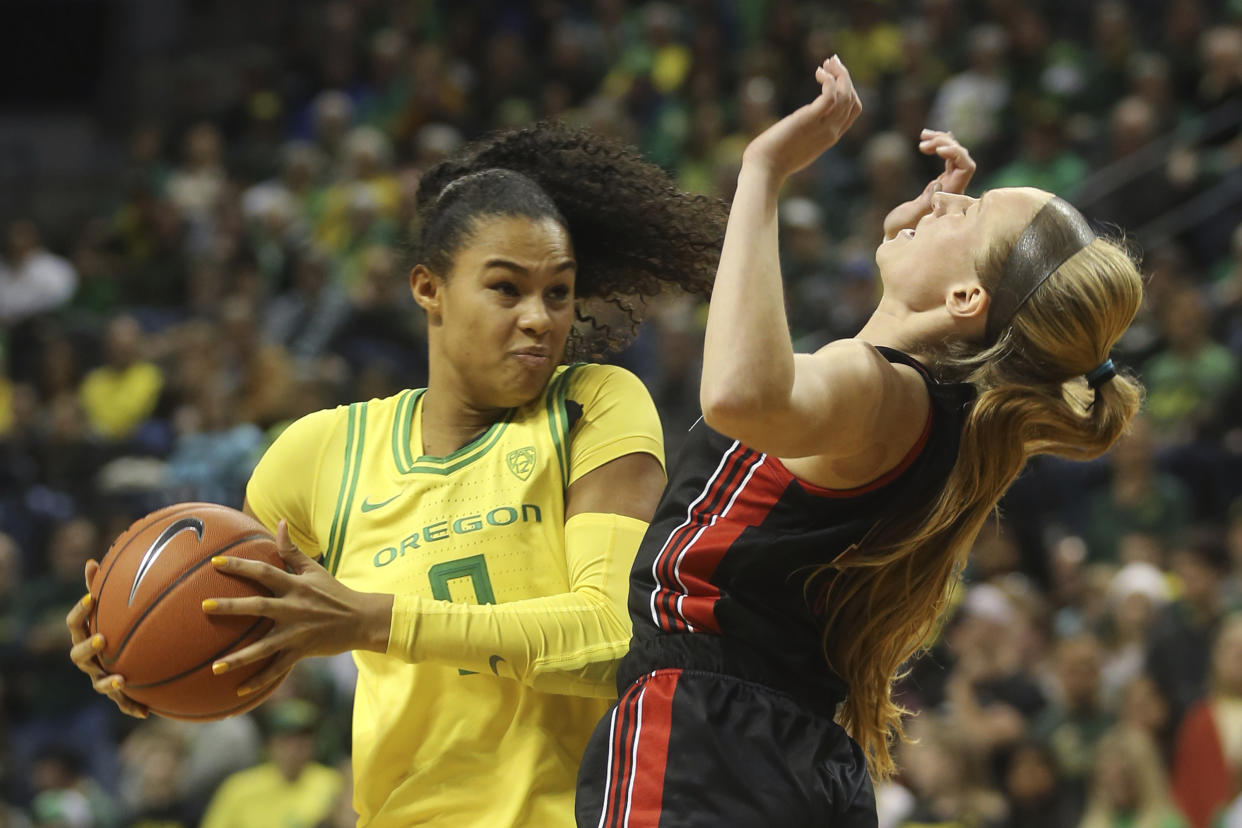 Oregon's Satou Sabally, left, picks up a player control foul against Utah's Dru Gylten during the second quarter of an NCAA college basketball game in Eugene, Ore., Sunday, Jan. 5, 2020. (AP Photo/Chris Pietsch)