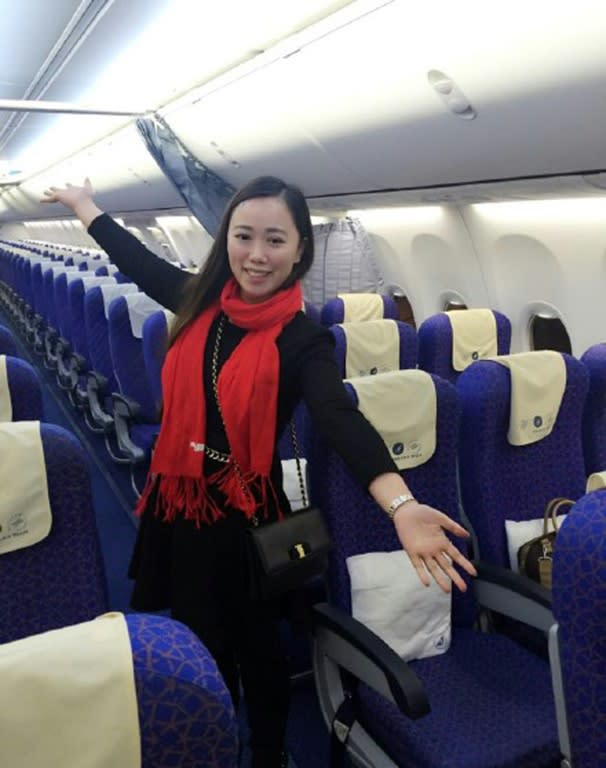 Zhang poses for photos on an empty China Southern's flight from Wuhan to Guangzhou, which normally seats 137 passengers