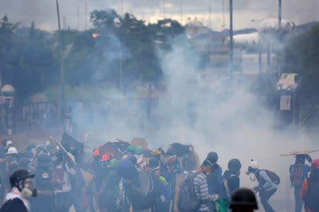 Demonstrators clash with riot security forces while rallying against Venezuelan President Nicolas Maduro's government in front of an Air Force base in Caracas, Venezuela, June 24, 2017. REUTERS/Ivan Alvarado