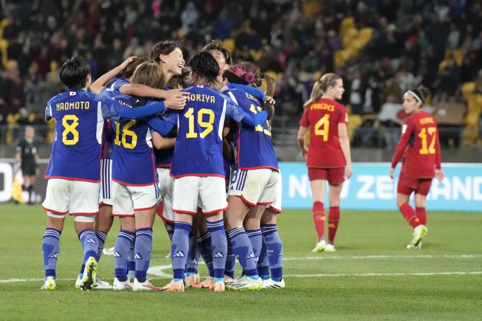 Japan's Mina Tanaka celebrates with teammates after scoring during a World Cup match against Spain