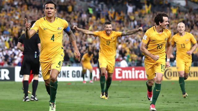 The Socceroos celebrate Cahill's winner. Image: Getty