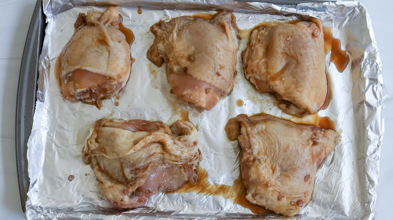 marinated chicken thighs on tray