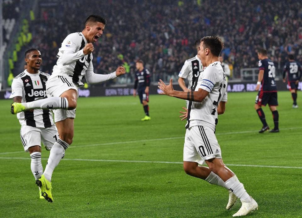 Juventus' Paulo Dybala, right, celebrates with his teammates after scoring his team's first goal during the Italian Serie A soccer match between Juventus and Cagliari at the Allianz Stadium in Turin, Italy, Saturday, Nov. 3, 2018. (Alessandro Di Marco/ANSA via AP)