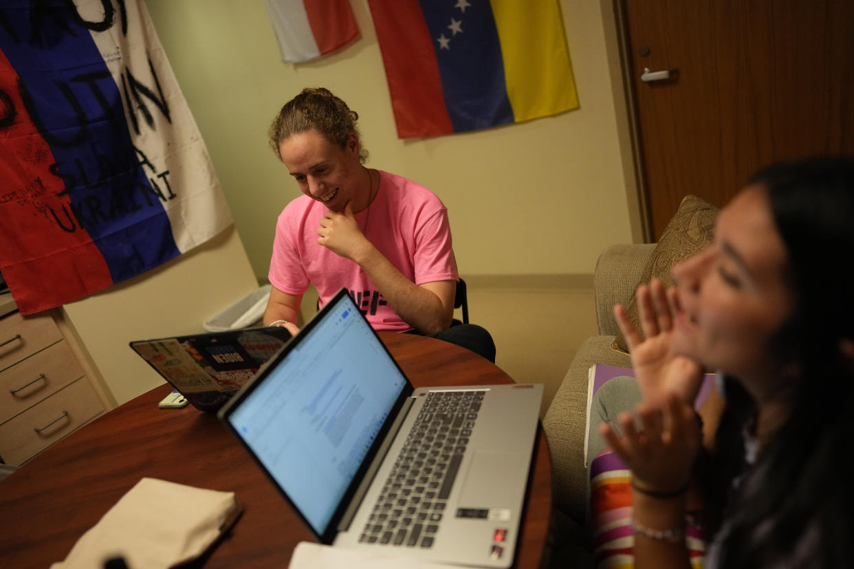 Joshua Epstein, left, a 17-year-old studying economics who wants to be a corporate lawyer or investment banker and describes himself as "so far from woke," talks with his Chilean roommate Karen Robertson as they study in the common room of their four-person dorm at New College of Florida, Wednesday, March 1, 2023, in Sarasota, Fla. Epstein, who says he considers himself liberal but has become more conservative since arriving on campus, would welcome more conservative students. But his main concern is government intervention in his education. "There's just a scary history of what happens when the state controls what gets taught in the classroom." (AP Photo/Rebecca Blackwell)