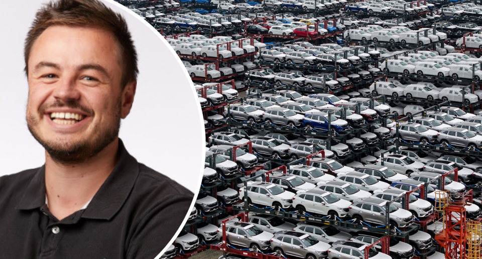 Paul Maric next to a fleet of EVs