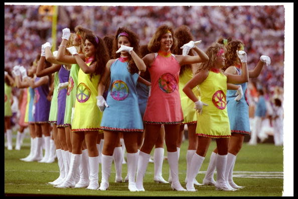 <div class="caption-credit"> Photo by: Getty Images/Mike Powell</div>It may look like your high school production of <i>Sweet Charity,</i> but really it's the big-time: the halftime show at Super Bowl XXV, in 1991, where faux go-go boots and poorly constructed '60s Mod mini-dresses (with tie-dyed…wagon wheels?) are somehow filling out the theme of "Small World." <br>