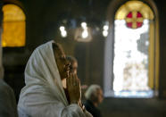 <p>An Egyptian Coptic Christian prays during a service for the departed remembering the victims of EgyptAir flight 804, at Al-Boutrossiya Church, the main Coptic Cathedral complex in Cairo, Egypt, May 22, 2016. The Airbus A320 plane was flying from Paris to Cairo with 66 passengers and crew when it disappeared early last Thursday over the Mediterranean Sea. (Amr Nabil/AP) </p>