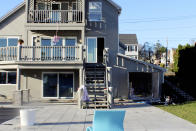 This photo, provided by the New London, Conn., Fire Department, shows fire damaged storage shed, at right, where Tony Hsieh, the retired CEO of the online shoe retailer Zappos died on Nov. 18, 2020. The cause of the fire that killed Hsieh could not be determined, a Connecticut investigator said in a report, Tuesday, Jan. 26, 2021. (New London Fire Department via AP)