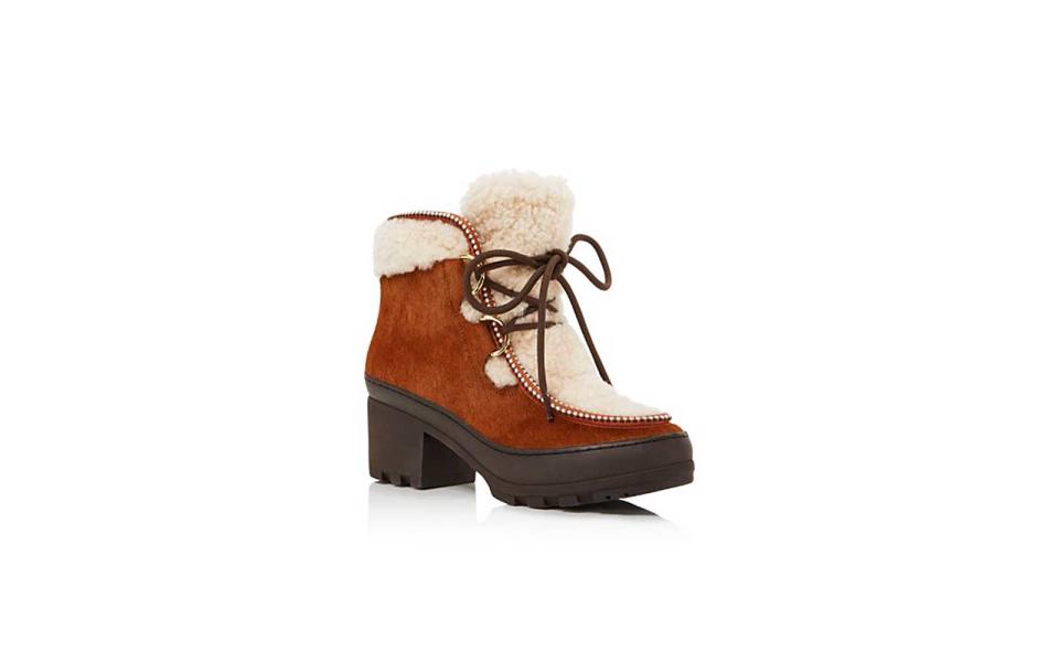 <p>We fell in love with these lace-up booties the second we saw them. The lug soles in combination with the sheep shearling strike the right balance between heavy duty and chic. The heel is almost 3 inches high but the 1.5-inch platform cancels out half of it making these beauties easy on the feet.</p> <p>To buy: <a rel="nofollow noopener" href="http://click.linksynergy.com/fs-bin/click?id=93xLBvPhAeE&subid=0&offerid=465536.1&type=10&tmpid=2425&RD_PARM1=http%3A%2F%2Fwww1.bloomingdales.com%2Fshop%2Fproduct%2Ftory-burch-berkley-calf-hair-sheep-fur-lace-up-booties%3FID%3D1749144%2526CategoryID%3D16961&u1=TLFASsheG1SnowBootsDZ1" target="_blank" data-ylk="slk:bloomingdales.com;elm:context_link;itc:0;sec:content-canvas" class="link ">bloomingdales.com</a>, $450</p>