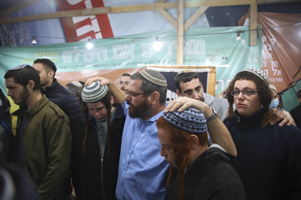 Mourners attend the funeral of Yehuda Dimentman, 25, who was killed in a shooting attack by a Palestinian gunman near the Jewish outpost of Homesh in the West Bank, Friday, Dec. 17, 2021. At least one Palestinian gunman opened fire Thursday night at a car filled with Jewish seminary students next to a West Bank settlement outpost, killing an Israeli man and lightly wounding two other people, Israeli officials said. (AP Photo/Moti Milrod)