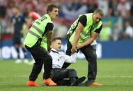 Soccer Football - World Cup - Final - France v Croatia - Luzhniki Stadium, Moscow, Russia - July 15, 2018 Stewards apprehend a pitch invader REUTERS/Carl Recine