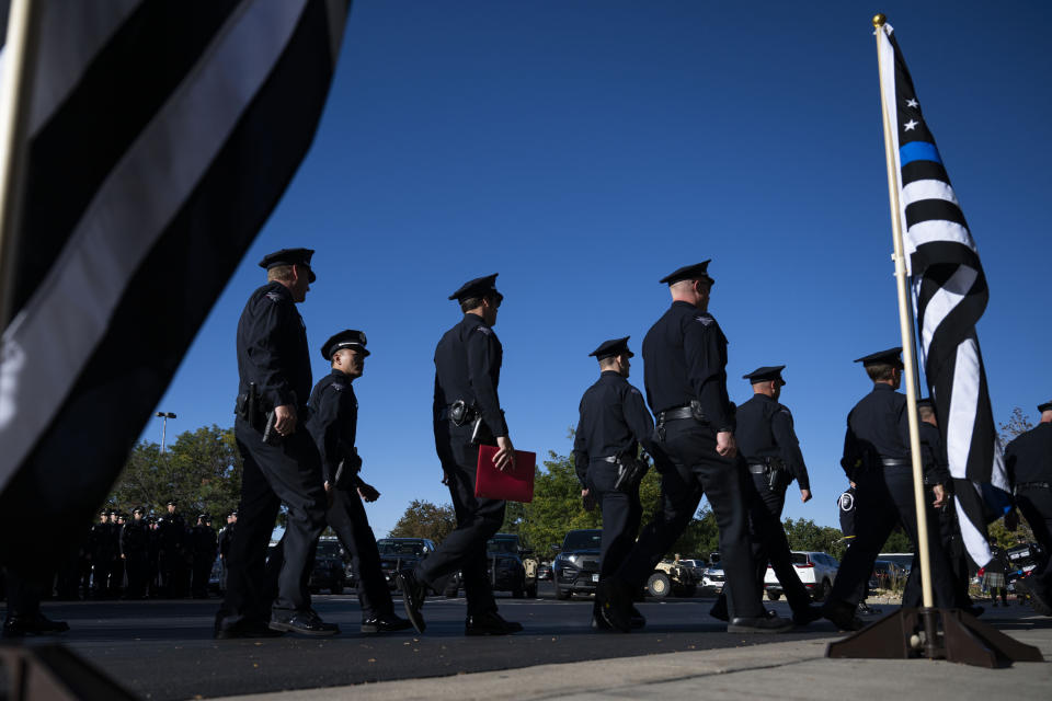 Police officers from surrounding areas enter the church following the funeral procession for fallen Arvada Police Officer Dillon Vakoff, Friday, Sept. 16, 2022, at Flatirons Community Church in Lafayette, Colo. Vakoff was fatally shot while trying to break up a large family disturbance earlier in the week, in Arvada. (Timothy Hurst/The Gazette via AP)