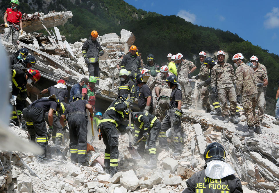 Rescuers work following an earthquake at Pescara del Tronto