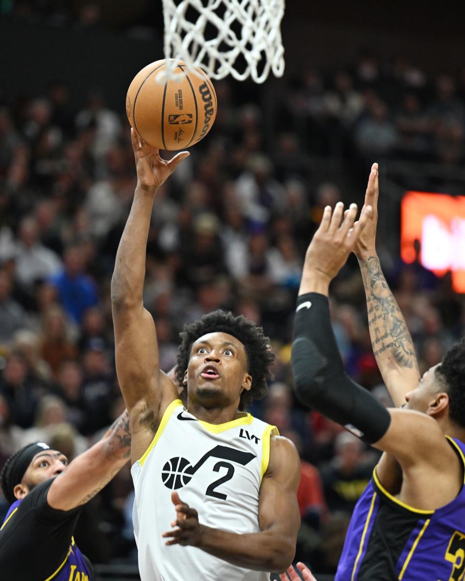 Utah Jazz guard Collin Sexton (2) pushes up a shot between Los Angeles Lakers forward Anthony Davis (3) and Los Angeles Lakers forward Christian Wood (35) as Utah and Los Angeles play at the Delta Center in Salt Lake City on Saturday, Jan. 13, 2024. | Scott G Winterton, Deseret News