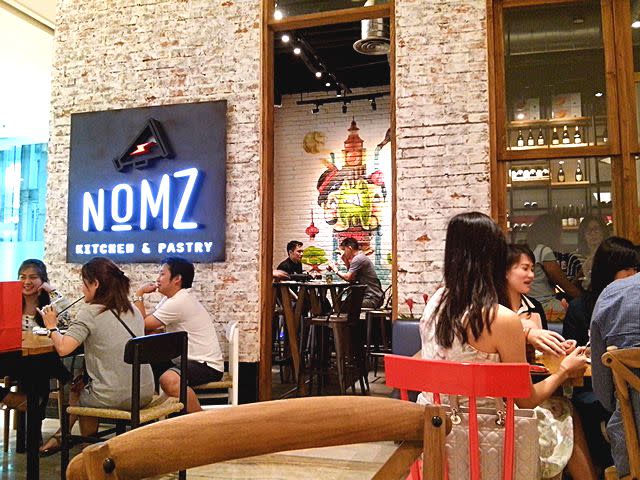Casual ambiance: The industrial-themed interior gives Nomz Kitchen & Pastry a casual ambiance, with bright color touches on tables and chairs.