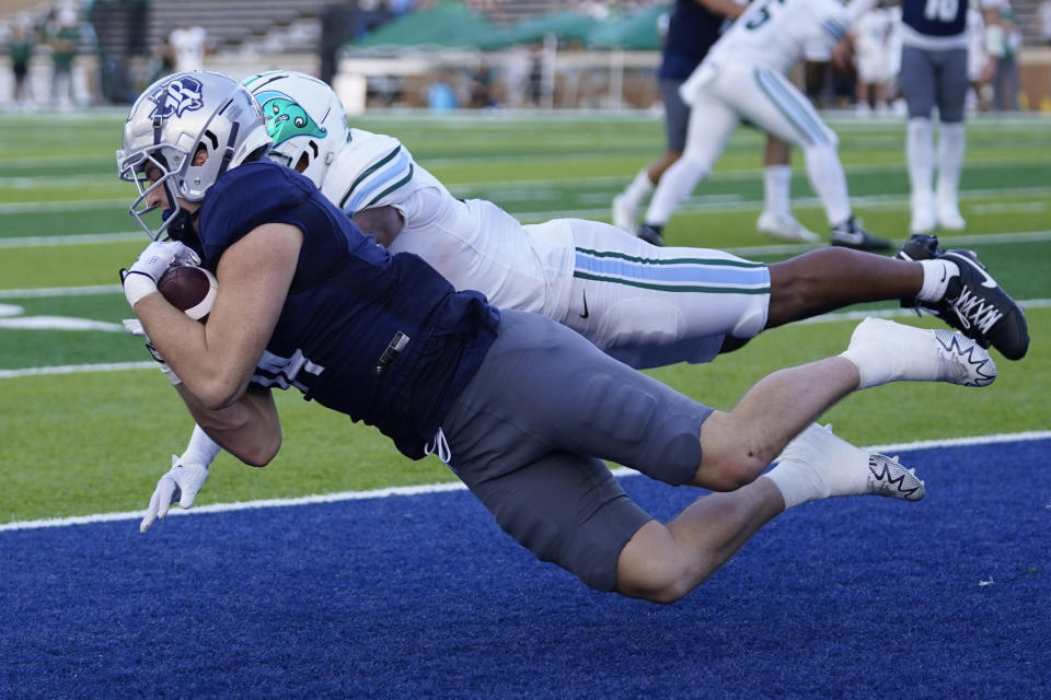 Rice tight end Boden Groen, front, catches a touchdown pass as Tulane defensive back DJ Douglas defends during the second half of an NCAA college football game, Saturday, Oct. 28, 2023, in Houston. (AP Photo/Eric Christian Smith)