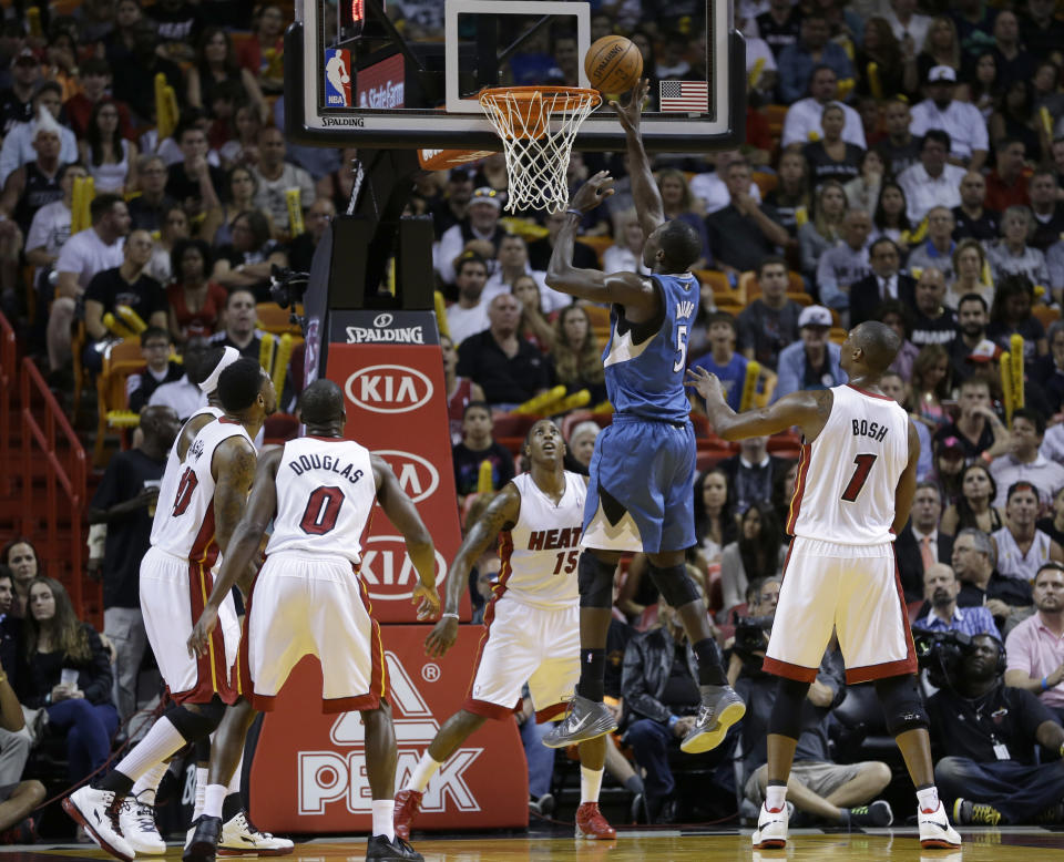 Minnesota Timberwolves center Gorgui Dieng (5) goes to the basket against the Miami Heat during the first half of an NBA basketball game in Miami, Friday, April 4, 2014. (AP Photo/Alan Diaz)