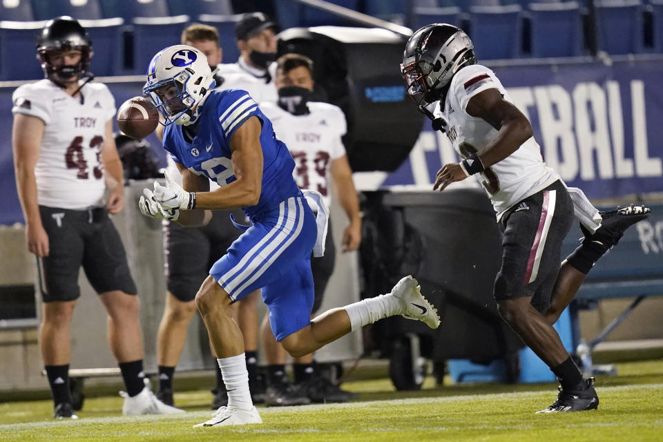 BYU wide receiver Gunner Romney, left, catches a pass next to Troy cornerback Zion Williams during the second half of an NCAA college football game Saturday, Sept. 26, 2020, in Provo, Utah. (AP Photo/Rick Bowmer, Pool)