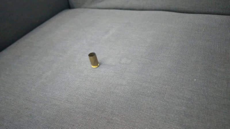 Ammunition casing lies on a couch after a shooting at a shopping mall in Bangkok