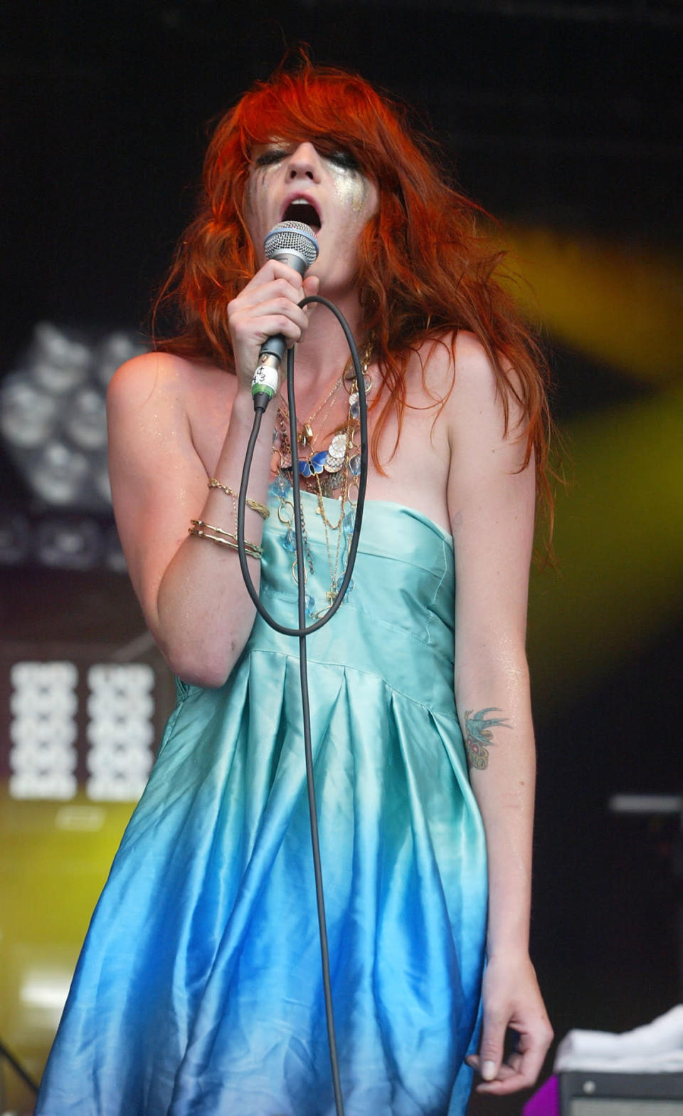 Florence Welch performs in a blue dress with smeared makeup in 2008. 