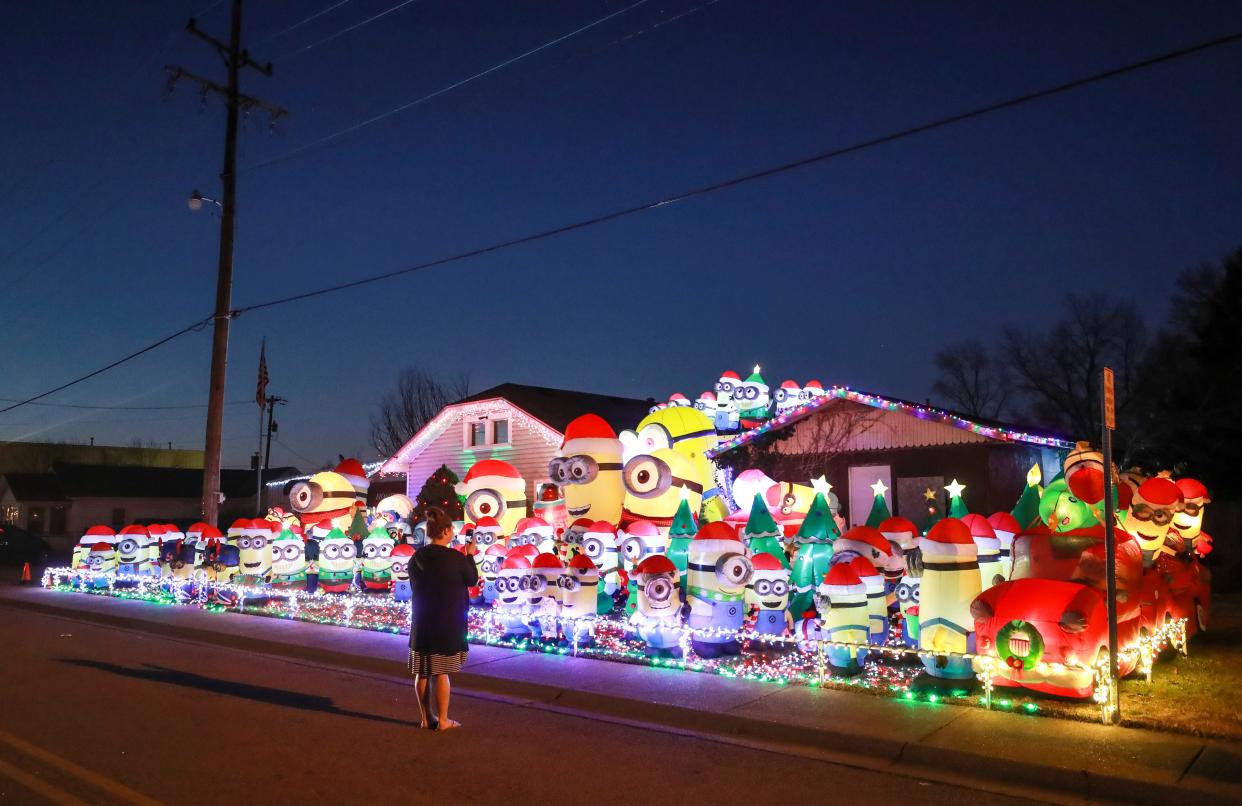 The more than 100 Minion inflatable figures have become an annual draw to this New Albany home in the 2000 block of Indiana Avenue. Mike Pourteau, homeowner and creator of this holiday exhibit, didn't even want to speculate the actual number of Minions in this display. "It hurts my head to think about it," he said with a wry tone. The colorful display draws delighted children and adults alike; hundreds of cars will pass by from dusk until around midnight, when Pourteau turns off the lights.