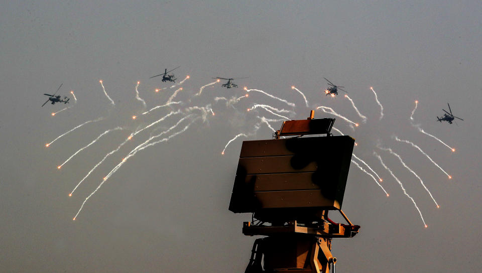Indian Air Force Apache helicopters fire flares during Air Force Day parade at Hindon Air Force Station on the outskirts of New Delhi, India, Thursday, Oct. 8, 2020. (AP Photo/Manish Swarup)