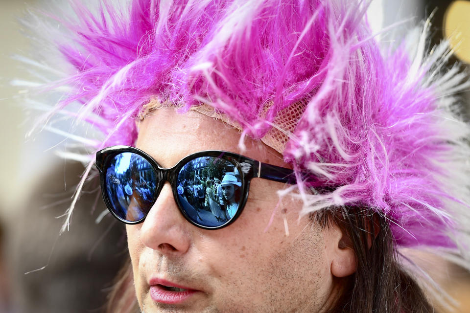 People taking part in a gay pride parade are reflected in a person's sunglasses in Budapest, Hungary, Saturday, July 24, 2021. Hungary's government led by right-wing Prime Minister Viktor Orban passed a law in June prohibiting the display of content depicting homosexuality or gender reassignment to minors, a move that has ignited intense opposition in Hungary while EU lawmakers have urged the European Commission to take swift action against Hungary unless it changes tack. (AP Photo/Anna Szilagyi)