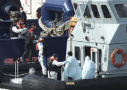 A Border Force vessel brings a group of people thought to be migrants into the port city of Dover, southern England, Sunday Aug. 9, 2020. Many migrants have used small craft during the recent hot calm weather to make the dangerous journey from northern France, to cross the busy shipping lanes of The Channel to reach Britain. (Yui Mok/PA via AP)