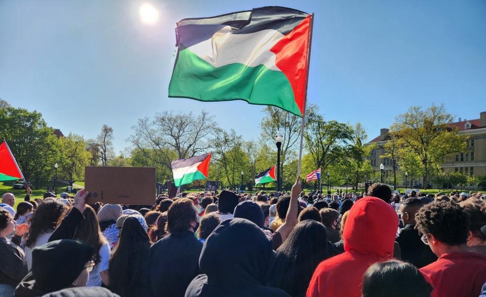 Protesters calling for Ohio State University to divest investment in businesses linked to Israel waved a Palestinian flag at a demonstration outside the Ohio Union on Thursday.