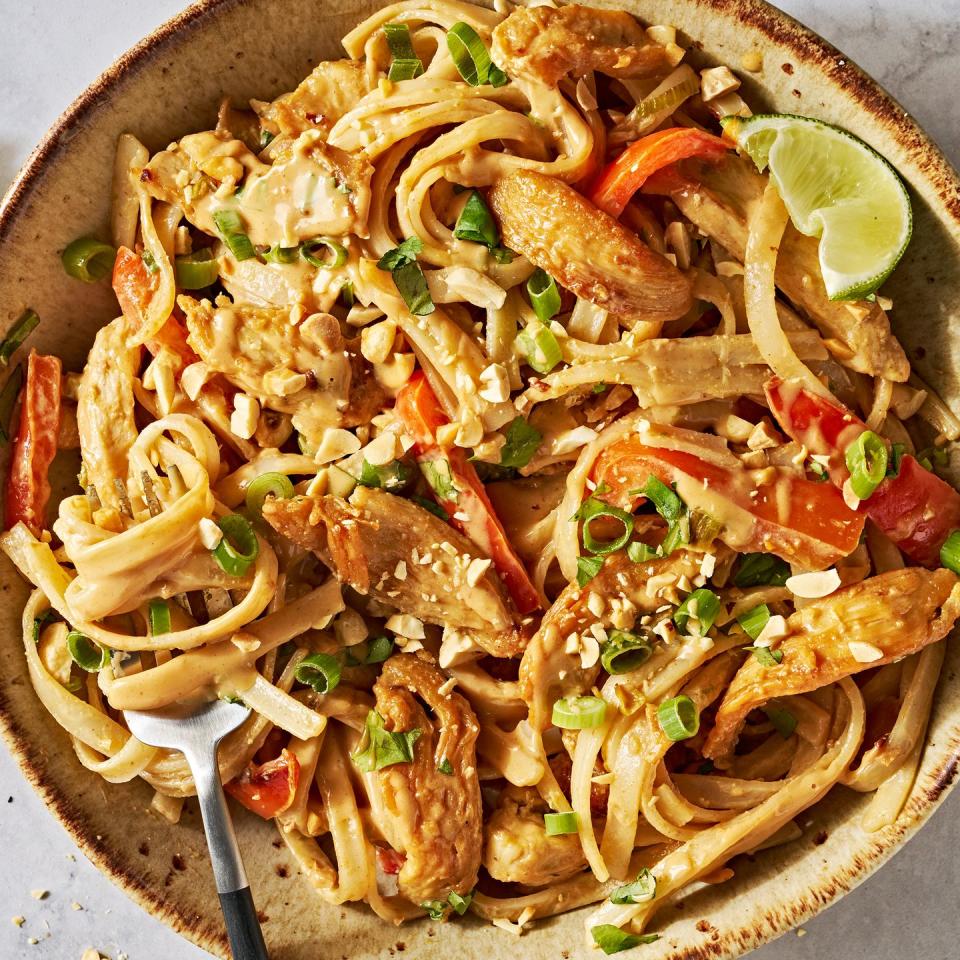 chicken with noodles and carrots in a creamy peanut lime sauce topped with peanuts