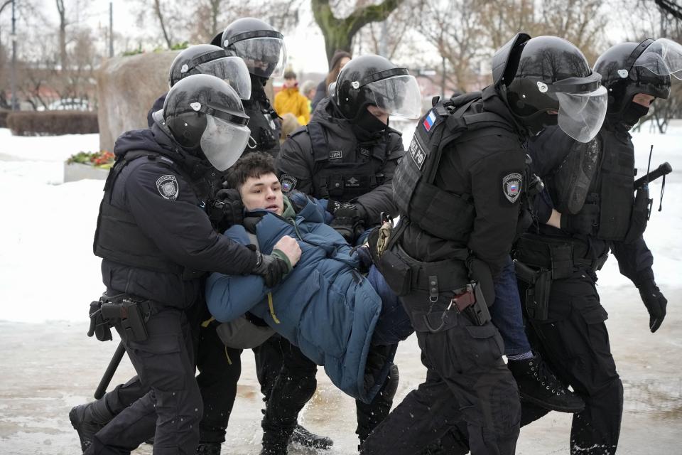 FILE - Police detain a man trying to lay flowers to honor Alexei Navalny at a monument in St. Petersburg, Russia, to victims of Soviet repression, on Saturday, Feb. 17, 2024. As Vladimir Putin heads for another six-year term as Russia’s president, there’s little electoral drama in the race. What he does after he crosses the finish line, however, is what’s drawing attention and, for many observers, provoking anxiety. (AP Photo, File)