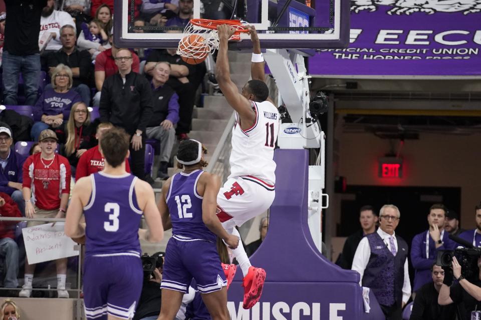 TCU's Francisco Farabello (3) and Xavier Cork (12) look on as Texas Tech forward Bryson Williams (11) dunks in the first half of an NCAA college basketball game in Fort Worth, Texas, Saturday, Feb. 26, 2022. (AP Photo/Tony Gutierrez)