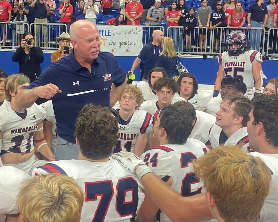 Fired-up Wimberley coach Doug Warren addresses his players after their 42-36 victory over Cuero on Friday at the Alamodome. The Texans rallied from a 30-17 deficit in the second half.