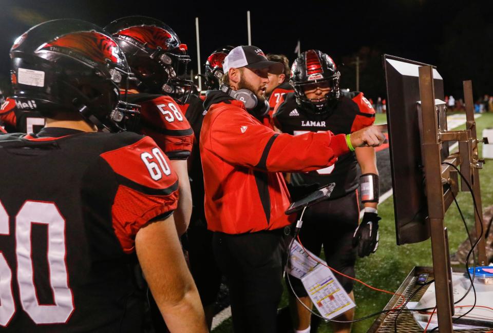 Lamar head coach Jared Beshore talks with players during the Tigers 35-7 win over Fair Grove in the district championship game at Lamar High School on Friday, Nov. 13, 2021.